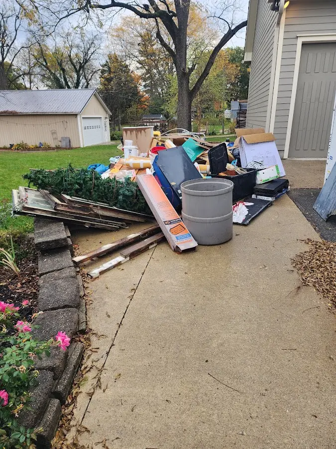 Dumpster being loaded with debris for Estate Cleanout Dumpster Rental in Romeoville